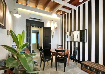 a dining room with black and white striped walls at Stylist Siamese Design House Steps To Chinatown - Self Check In in Bangkok