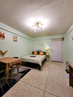 a room with a bed and a table and a door at 808-STP Homely room Free Wi-Fi and Near BTS in Sathani Bang Khen