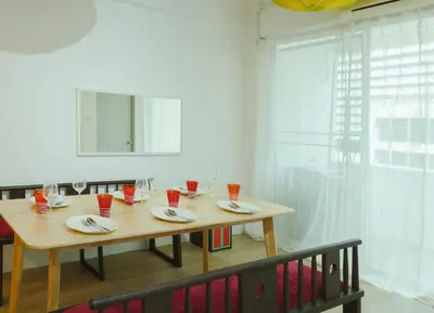 a dining room table with red cups and plates on it at 2 BR Sleeps6 I City Center Silom in Bangkok