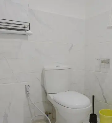 a white bathroom with a toilet and a sink at 2 BR Sleeps6 I City Center Silom in Bangkok