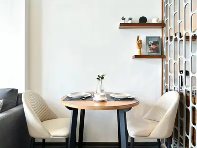 a dining room with a table and white chairs at Urban Chic Living - 1BR - Ultra Fast WiFi - BTS Asoke in Bangkok
