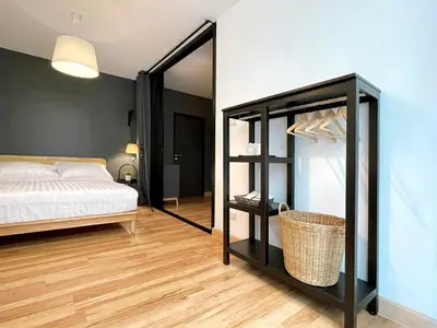 a bedroom with a bed and a mirror at Vélin - Samsen in Bangkok