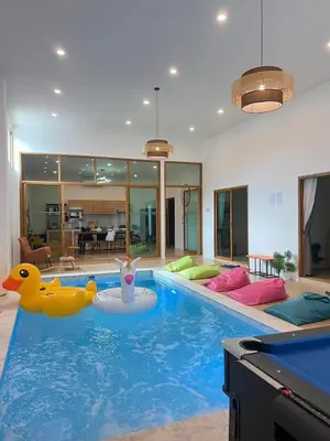 a swimming pool with a rubber duck in a house at นวมินทร์ 76 พูลวิลล่า - Nawamin 76 Poolwilla in Ban Baen Phichit