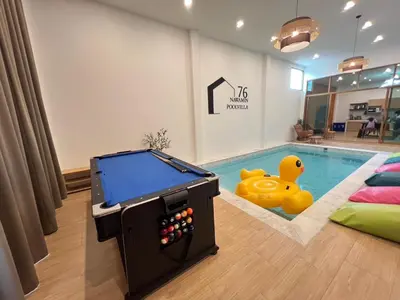 a pool with a toy duck next to a swimming pool at นวมินทร์ 76 พูลวิลล่า - Nawamin 76 Poolwilla in Ban Baen Phichit