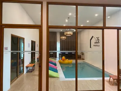 a living room with a pool and a house at นวมินทร์ 76 พูลวิลล่า - Nawamin 76 Poolwilla in Ban Baen Phichit