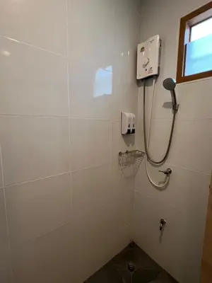 a bathroom with a shower with a phone on the wall at นวมินทร์ 76 พูลวิลล่า - Nawamin 76 Poolwilla in Ban Baen Phichit
