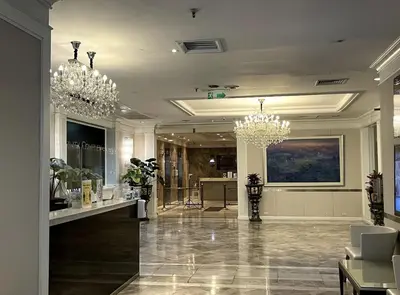 a large lobby with chandeliers and a store at Trinity City View 3BR Spacious Family Silom in Bangkok