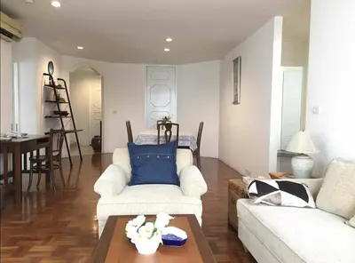 a living room with two white couches and a table at Trinity City View 3BR Spacious Family Silom in Bangkok