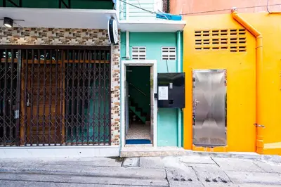 an entrance to a building with a green door at xxGO INN The Giant Swing - เสาชิงช้า in Bangkok