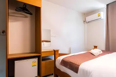 a small bedroom with a bed and a desk at XX GO INN Khaosan - โกอินน์ ถนนข้าวสาร in Bang Bua Thong Railway Station