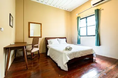 a bedroom with a bed and a desk and a window at xx Rest Inn Yaowarat Bangkok - เรสอินน์ เยาวราช in Samphanthawong