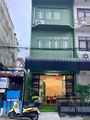 a scooter parked in front of a building at 326 Podtel at The Breakie Bar in Bangkok