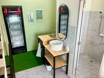 a bathroom with a sink and a mirror at 326 Podtel at The Breakie Bar in Bangkok