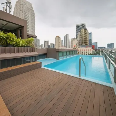 a rooftop swimming pool on the roof of a building at Central next to Shopping 1 Bedroom Condo - 2 Min to BTS Asok and Terminal 21 in Bangkok