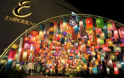 a building with a bunch of lights hanging from it at I LOVE BANGKOK - Thai Style Room near Skytrain Asok, T21, and EM District Malls in Bangkok