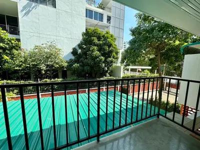 a swimming pool with a black railing next to a building at I LOVE BANGKOK - Thai Style Room near Skytrain Asok, T21, and EM District Malls in Bangkok