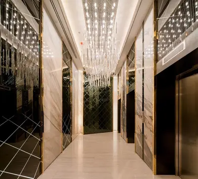 a hallway of a building with a chandelier at 1 Bedroom at Q Chidlom in Bangkok