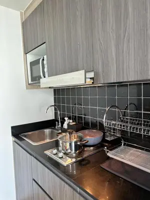 a kitchen with a sink and a counter top at Resort style family room near BTS Bearing in Ban Khlong Samrong