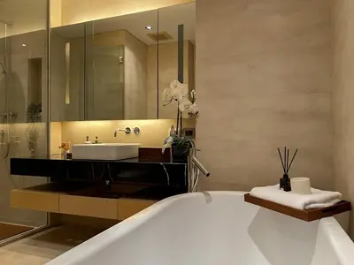 a bathroom with a large tub and a sink at Saladaeng Residences at Silom in Bangkok
