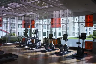 a gym with cardio equipment in front of a large window at Supalai Wellington 2, near MRT in Sathani Khlong Tan