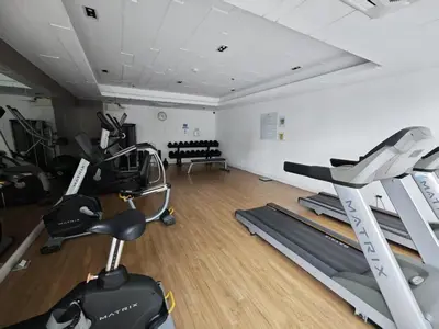 a gym with treadmills and ellipticals in a room at BTS sukhumvit Line onnut station in Bangkok