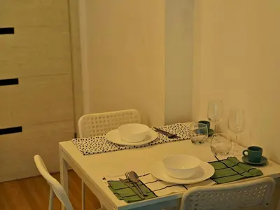 a dining room table with plates and glasses on it at BTS sukhumvit Line onnut station in Bangkok