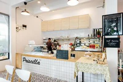a man is standing at the counter of a restaurant at Homemade Ice cream house in local village in Bangkok