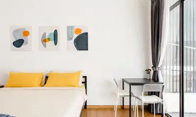 a bedroom with a bed and a desk and a table at Homemade Ice cream house in local village in Bangkok
