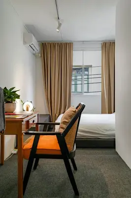 a room with a desk and a chair and a bed at Nap Boriphat in Bangkok