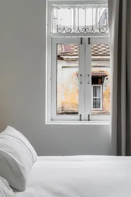 a bedroom with a window and a bed with a pillow at Nap Boriphat in Bangkok