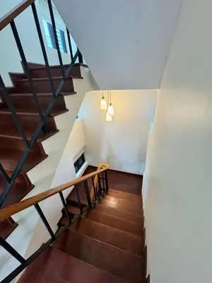 a staircase in a house with wooden floors at Central BKK Luxuxy Pool Villa 4BR in Bangkok