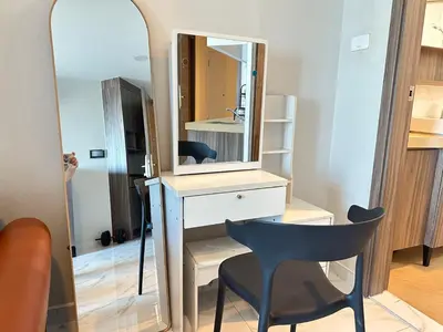 a mirror and a desk and a chair in a room at Artisan Ratchada Prime Studio Condos in Bangkok