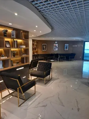 a lobby with chairs and tables in a building at Artisan Ratchada Prime Studio Condos in Bangkok