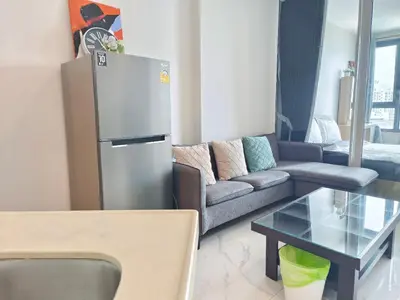 a living room with a refrigerator and a couch at Artisan Ratchada Prime Studio Condos in Bangkok