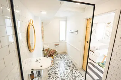 a bathroom with a sink and a mirror at Old Town Heritage Lofts Bangkok in Bangkok