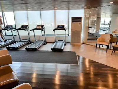 a gym with several treadmills in a building at Artisan Ratchada Spacious 2BR Condos in Bangkok