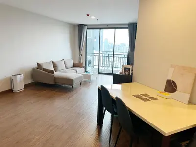 a living room with a couch and a table at Artisan Ratchada Spacious 2BR Condos in Bangkok