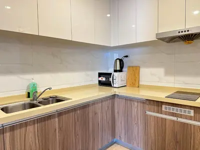 a kitchen with a sink and a microwave at Artisan Ratchada Spacious 2BR Condos in Bangkok