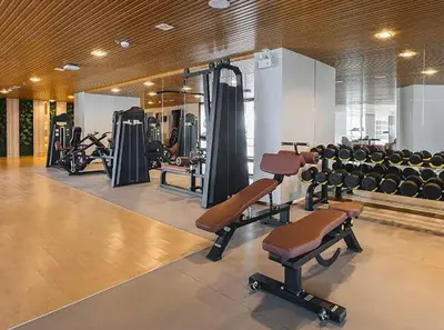 a gym with lots of exercise equipment and weights at Artisan Ratchada Spacious 2BR Condos in Bangkok