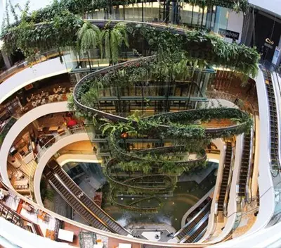 a large building with escalators and plants on it at 2 Bed 2 Bath Phrom Phong BTS in Bangkok