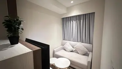 a living room with a couch and a window at Paradise condo-perfect location in Bangkok