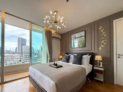 a bedroom with a large bed and a large window at Spacious City 69 SQM - Fast WiFi - BTS Chong Nonsi in Bangkok