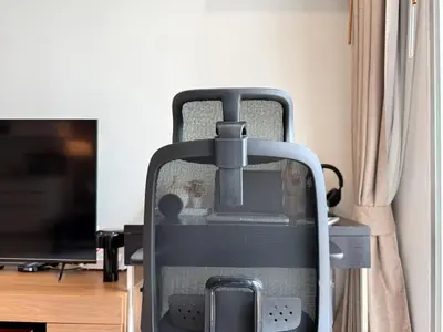 a room with a desk with a chair and a television at Spacious City 69 SQM - Fast WiFi - BTS Chong Nonsi in Bangkok