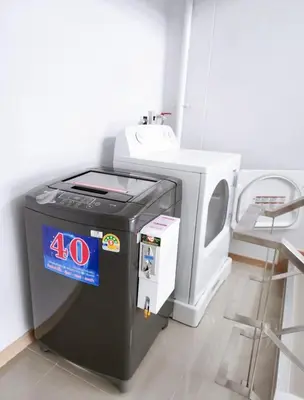 a video game machine sitting next to a tv at Wonderful Stay BTS Ratchayothin in Bangkok