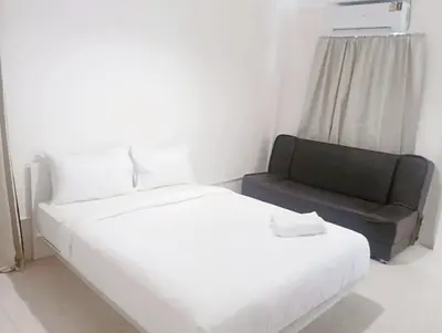 a white bed and a couch in a room at xx Mitr INN Sukhumvit 2 - BTS Nana มิตร อินน์ สุขุมวิทซอย 2 บีทีเอส นานา in Bangkok