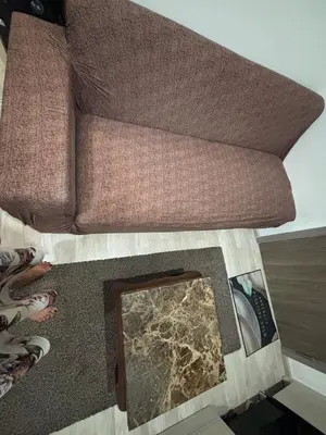 a living room with a couch and a mirror at Nich Mono Ramkhumheng Low Rise in Sathani Ban Hua Mak