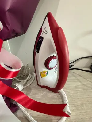 a red and white phone with a red ribbon at Nich Mono Ramkhumheng Low Rise in Sathani Ban Hua Mak