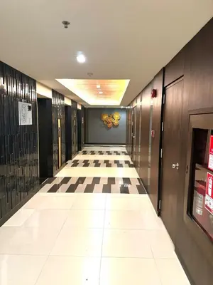 a hallway with a checkered floor in a building at Super City View Room, Swimming Pool,Gym,150m walk to BTS in Bangkok