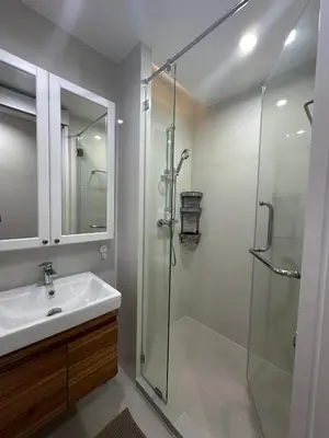a bathroom with a glass shower and a sink at 6th Avenue Sukhumvit BKK 301 BTS Asoke Nana MRT in Bangkok