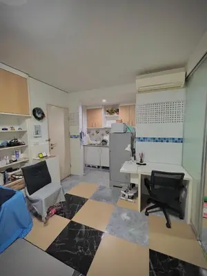 a room with a desk and chairs and a kitchen at Condo with Pool View & Great Amenities Bangkok in Sathani Ban Hua Mak